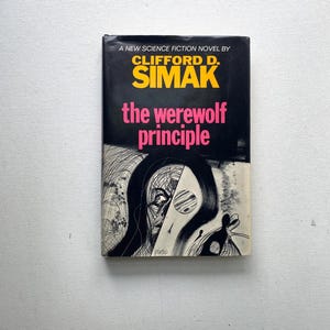 May include: A vintage paperback book titled "The Werewolf Principle" by Clifford D. Simak. The cover is black with yellow and pink text. An illustration of a face and abstract shapes is on the cover.