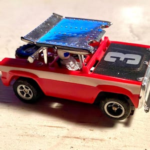 Working AURORA AFX Red and Black Baja Bronco HO Slot Car