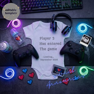 May include: A baby announcement with a white babygrow printed with "Player 3 Has entered The game Loading... September 2026". The image includes two black game controllers, a baby bottle, a can, and a retro game cartridge.