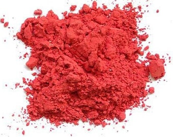 May include: A pile of bright red powder, likely used for crafts or painting.