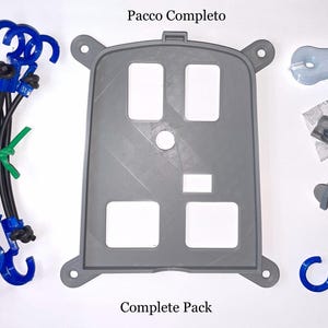 May include: An assortment of gray and blue hardware components, including a large gray panel with square cutouts, blue hooks, and various fasteners. The text "Complete Pack" is visible.
