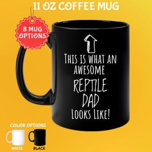 May include: Black 11 oz coffee mug with the text "THIS IS WHAT AN AWESOME REPTILE DAD LOOKS LIKE!" in white. The mug has a black handle and a white arrow graphic. Color options include white and black.