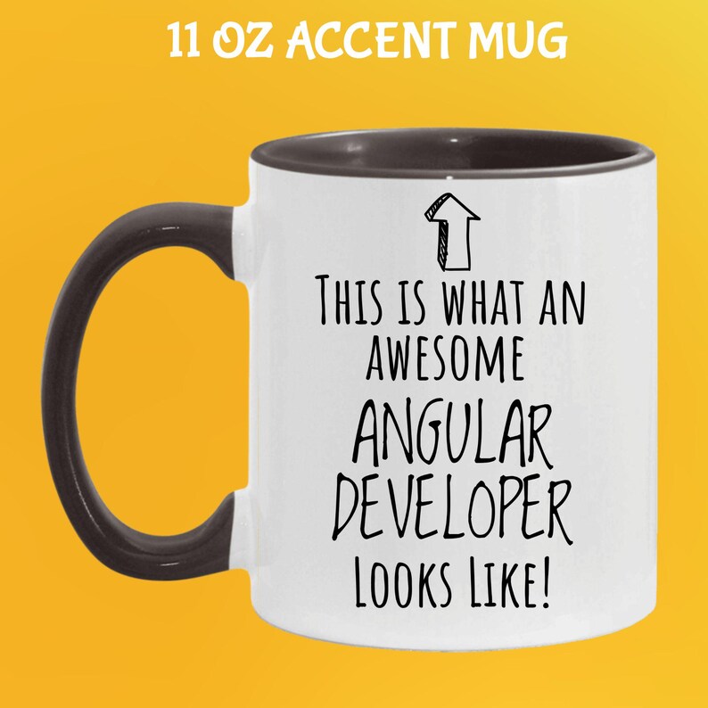 May include: White 11 oz accent mug with a black handle and rim. The mug features the text "THIS IS WHAT AN AWESOME ANGULAR DEVELOPER LOOKS LIKE!" in black, with an arrow graphic.