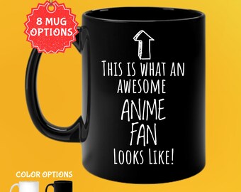 May include: Black 11 oz coffee mug with the text "THIS IS WHAT AN AWESOME ANIME FAN LOOKS LIKE!" in white. The mug has a black handle and a white arrow graphic. Color options are white and black.