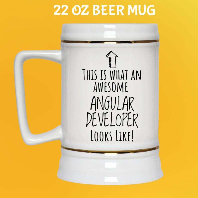 May include: A white 22 oz beer mug with gold trim and a handle. The mug has the text "THIS IS WHAT AN AWESOME ANGULAR DEVELOPER LOOKS LIKE!" in black. The mug is on a yellow background.