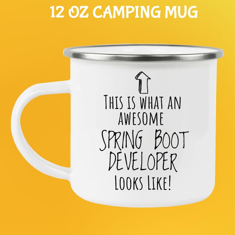 May include: White 12 oz camping mug with a silver rim and handle. The mug features the text "THIS IS WHAT AN AWESOME SPRING BOOT DEVELOPER LOOKS LIKE!" in black. The words "12 OZ CAMPING MUG" are at the top.