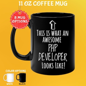 May include: Black 11 oz coffee mug with the text "THIS IS WHAT AN AWESOME PHP DEVELOPER LOOKS LIKE!". The mug has a black handle and the text is in white. Color options include white and black.