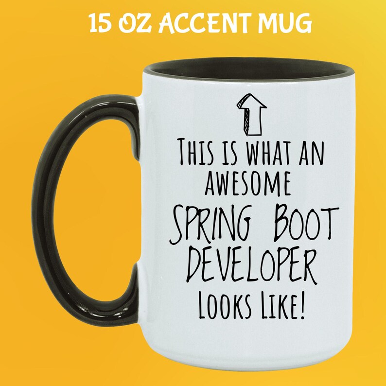May include: White 444 ml accent mug with a black handle and rim. The mug features the text "THIS IS WHAT AN AWESOME SPRING BOOT DEVELOPER LOOKS LIKE!" in black, with an arrow graphic.
