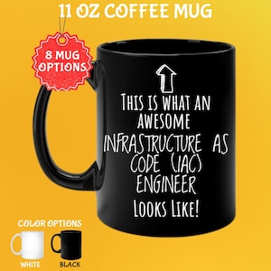May include: Black 312g coffee mug with the text "THIS IS WHAT AN AWESOME INFRASTRUCTURE AS CODE (IAC) ENGINEER LOOKS LIKE!" in white. The mug has a black handle and the words "8 MUG OPTIONS" are on a red tag. Color options are white and black.