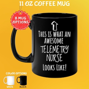 May include: Black 11 oz coffee mug with the text "THIS IS WHAT AN AWESOME TELEMETRY NURSE LOOKS LIKE!" in white. The mug has a black handle and a white arrow graphic. Color options include white and black mugs.