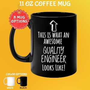 May include: Black 325 ml coffee mug with the text "THIS IS WHAT AN AWESOME QUALITY ENGINEER LOOKS LIKE!" in white. The mug has a black handle and a white arrow graphic. Color options include white and black mugs.