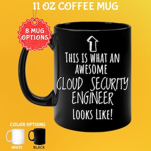 May include: Black 325 ml coffee mug with the text "THIS IS WHAT AN AWESOME CLOUD SECURITY ENGINEER LOOKS LIKE!" in white. The mug has a black handle and is available in white and black. A red tag reads "8 MUG OPTIONS".