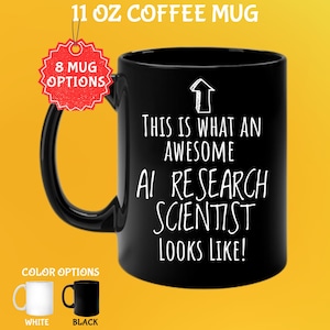 Op de afbeelding: Zwarte 325 ml koffiemok met de tekst "THIS IS WHAT AN AWESOME AI RESEARCH SCIENTIST LOOKS LIKE!". De mok heeft een zwart oor en is verkrijgbaar in wit en zwart. Een rood label geeft 8 mokopties aan.