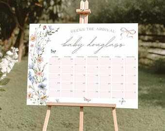 Puede incluir: Un letrero de baby shower rosa claro sobre un caballete con el texto "GUESS THE ARRIVAL baby douglass". El letrero tiene un diseño de calendario con ilustraciones florales y de mariposas. El caballete es de madera.
