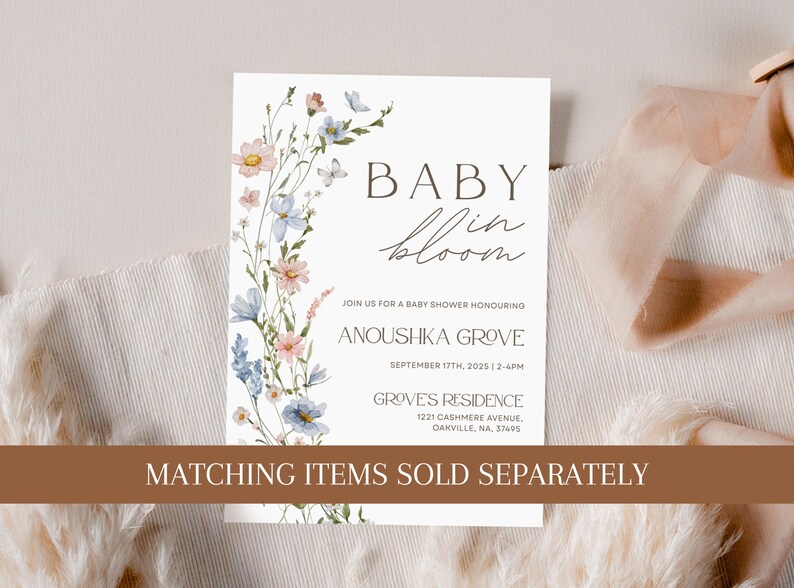 May include: A white baby shower invitation with a floral border. The text reads "Baby in Bloom" and includes the details of the event: "Join us for a baby shower honouring Anoushka Grove, September 17th, 2025, 2-4pm, Groves Residence, 1221 Cashmere Avenue, Oakville, NA, 37495". The bottom of the invitation reads "Matching items sold separately."