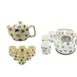 May include: A white ceramic tea set with a teapot and six cups. The teapot and cups are decorated with a colourful butterfly pattern. The teapot has a strainer.