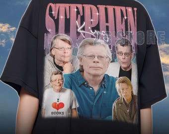 May include: Black unisex t-shirt featuring multiple images of Stephen King with the text "STEPHEN" in a pink and purple gradient. The shirt also includes the text "I BOOKS" on a white shirt.
