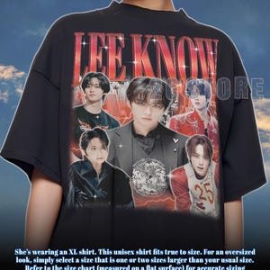 May include: Black unisex t-shirt featuring a graphic of Lee Know with the text "LEE KNOW" in red. The shirt has multiple images of Lee Know. The text "25" is visible on the shirt. The shirt is an XL size.