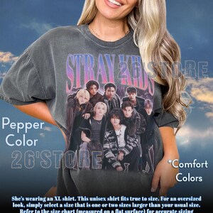 May include: Pepper color unisex t-shirt featuring a group of people with the text "STRAY KIDS 26 STORE" in a gradient font. The shirt also has the text "*Comfort Colors".