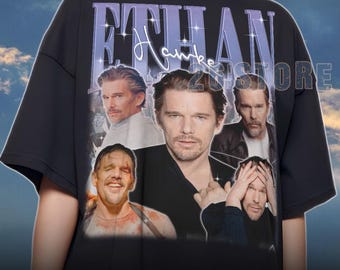 May include: Black unisex t-shirt featuring a collage of Ethan Hawke images with the name "ETHAN Hawke" in a stylized font. The shirt includes the text "2U STORE" and sizing information.