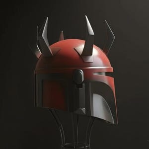 May include: A red and black helmet with multiple horns, displayed on a black metal stand. The helmet has a glossy finish and a distinctive design, likely for cosplay or display. The background is a dark, solid colour.