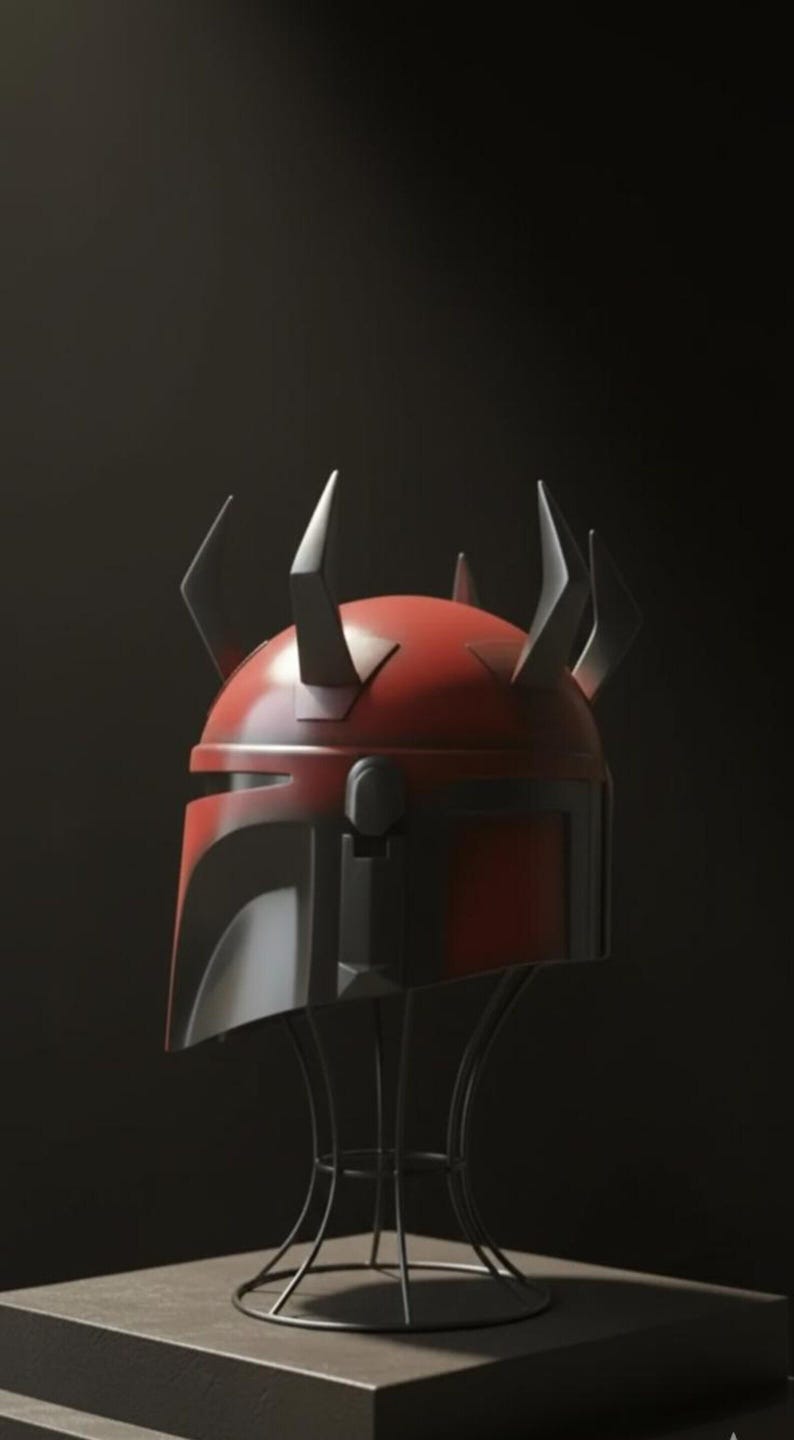 May include: A red and black helmet with pointed horns, displayed on a wire stand. The helmet has a distinctive design with a visor and angular features. The horns are black and add a unique element to the overall aesthetic.
