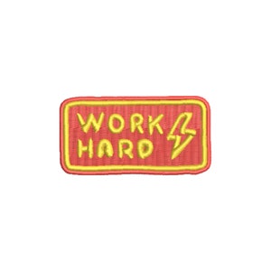 May include: A red embroidered patch with a yellow outline. The patch says "WORK HARD" with a lightning bolt symbol.