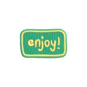 May include: A green and yellow embroidered patch with the word "enjoy!" in a yellow cursive font.