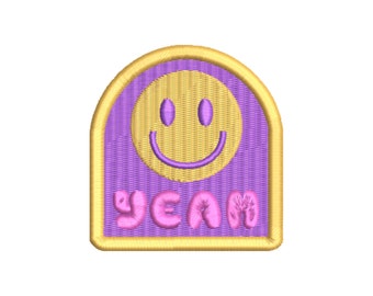 May include: Purple and yellow embroidered patch with a smiley face and the word "YEAN" in pink letters.