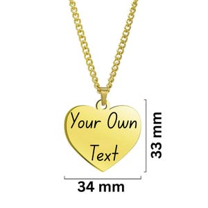 May include: A gold-colored heart-shaped pendant necklace with the text "Your Own Text". The pendant measures 34 mm wide and 33 mm high. The necklace has a gold chain.