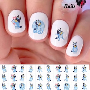 May include: Bluey nail decals featuring Bluey and Bingo in various poses. The decals are printed on white paper and are ready to be applied to nails. There are 24 decals in total.