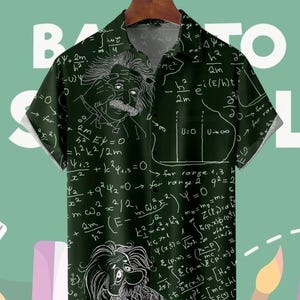 May include: Dark green button-down shirt featuring a white illustration of Albert Einstein and mathematical equations. The short-sleeved shirt has a classic collar and is made of a lightweight fabric.