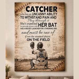 May include: A sepia-toned baseball-themed wall art print. The text reads "Catcher" and describes the catcher's abilities. A baseball player in uniform is in the catcher's stance. The player's jersey has the name "William" and the number "20".