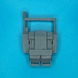 May include: A gray plastic model truck cab with a raised cab and a flatbed. The model has a detailed interior and exterior, including a grill, headlights, and taillights. The model is made of plastic and is designed for assembly.