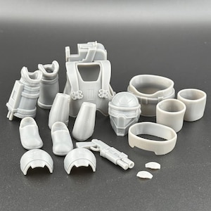 May include: A set of gray plastic action figure accessories, including a helmet, chest piece, leg pieces, and a rifle. The accessories are designed for a science fiction or fantasy character.