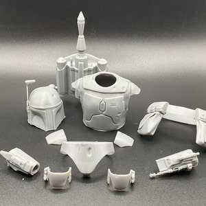 May include: A set of gray plastic parts for a Boba Fett action figure. The set includes the helmet, chest plate, jetpack, and other pieces.
