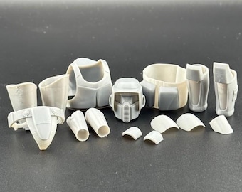 May include: A collection of unpainted, light gray plastic model kit parts. The components include a helmet, chest armor, shoulder pads, and other pieces, likely for a sci-fi or military figure. The parts are arranged on a dark surface.