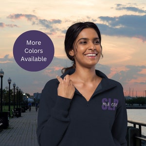 May include: A dark blue fleece pullover with a purple embroidered logo that says "SLP M.S. CCC".