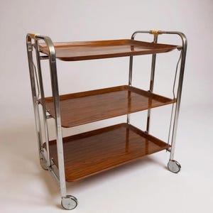 Folding Serving Trolley “Dinett” attributed to Bremshey – vintage bar cart – chrome & teak look – German 1970s mid-century design