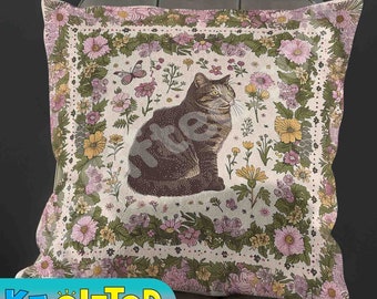 May include: A square throw pillow featuring a central illustration of a brown tabby cat surrounded by a floral border of pink, yellow, and green flowers and a butterfly. The background is off-white with a repeating pattern of small flowers.