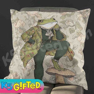 May include: A green frog wearing a green and gold patterned jacket and pants sits on a mushroom with a floral background.