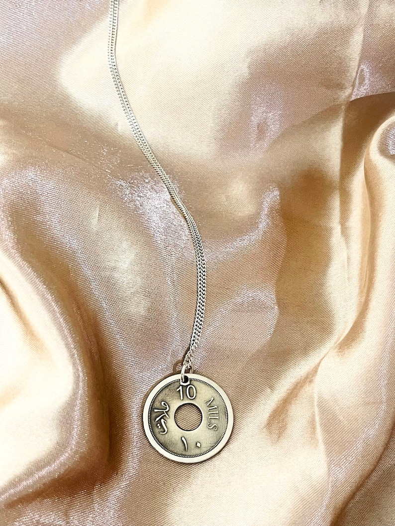 This piece represents the 1927 10 or 5 Mil coin. (Double-sided coin). Can be worn on both sides!
Handmade in Palestine of high quality sterling silver.
