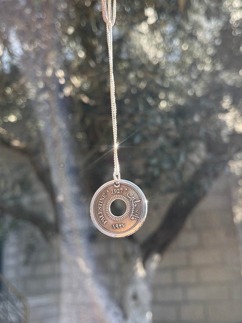 This piece represents the 1927 10 or 5 Mil coin. (Double-sided coin). Can be worn on both sides!
Handmade in Palestine of high quality sterling silver.