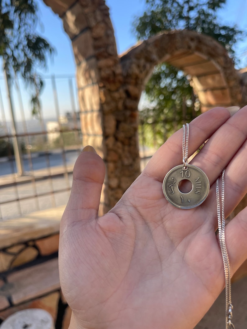 This piece represents the 1927 10 or 5 Mil coin. (Double-sided coin). Can be worn on both sides!
Handmade in Palestine of high quality sterling silver.