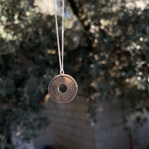 This piece represents the 1927 10 or 5 Mil coin. (Double-sided coin). Can be worn on both sides!
Handmade in Palestine of high quality sterling silver.