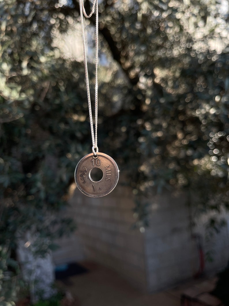 This piece represents the 1927 10 or 5 Mil coin. (Double-sided coin). Can be worn on both sides!
Handmade in Palestine of high quality sterling silver.