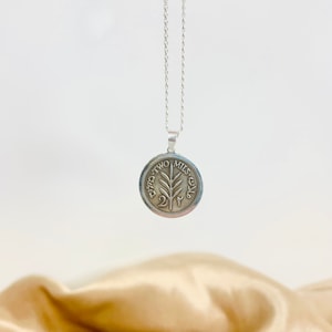 This piece represents the 1927 2 Mil coin. (Double-sided coin). Can be worn on both sides!
Handmade in Palestine of high quality sterling silver.