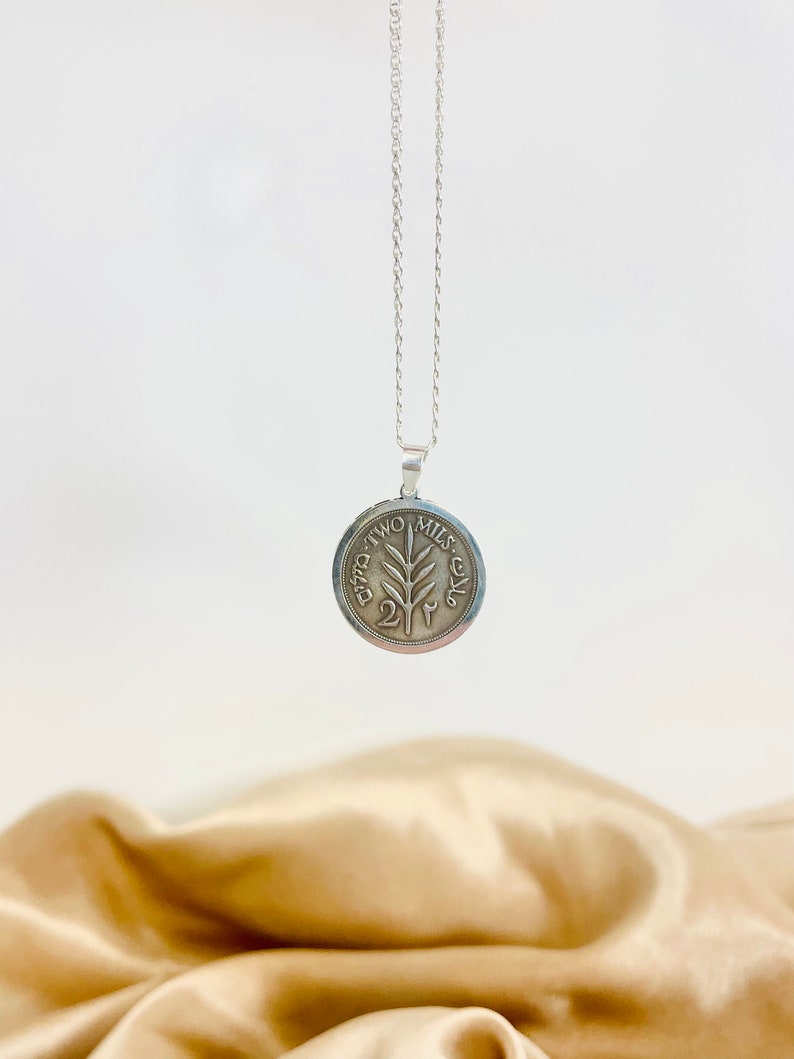 This piece represents the 1927 2 Mil coin. (Double-sided coin). Can be worn on both sides!
Handmade in Palestine of high quality sterling silver.