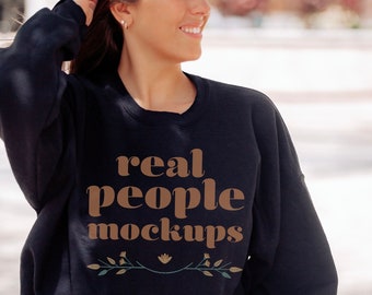 May include: A black sweatshirt with the text "real people mockups" in brown lettering and a small floral design below the text.