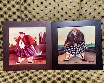 JENNIFER GARANT Tile Trivet/ Wall Decor.Solid wood frame 8”x 8”. “ Chubby Golfing “.Set of Two.Metal hardware on the back.Used condition.